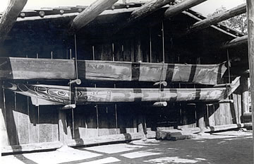 Two canoes inside the open sided structure