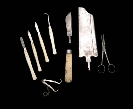 Post-Morten Surgical kit, this kit includes several scalpels, a saw, bowel scissors and chain hooks