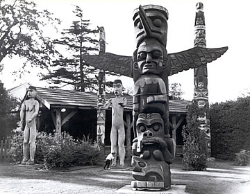 Welcome figures with other totem poles