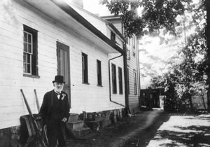 Dr Helmcken standing beside his house 1917