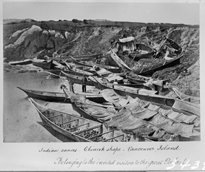 Canoes belonging to visitors attending a potlatch on the Old Songhees Reserve in 1869
